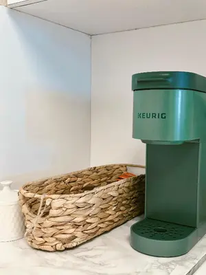a green machine next to a basket on a table at Pavilion Beach Front Apartment with Balcony in Miami Beach