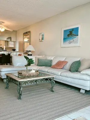 a living room with a white couch and a coffee table at Pavilion Beach Front Apartment with Balcony in Miami Beach