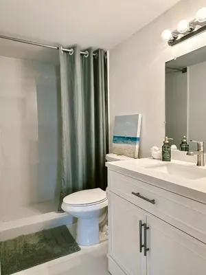 a bathroom with a toilet and a sink and a shower at Pavilion Beach Front Apartment with Balcony in Miami Beach
