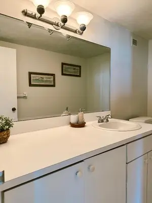 a bathroom with a sink and a large mirror at Pavilion Beach Front Apartment with Balcony in Miami Beach