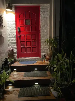 a red door with a step in front of it at Ne Miami Cottage in Miami