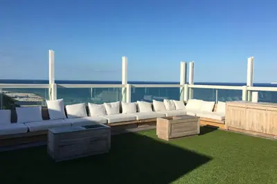 a living room with white couches on a balcony at Incredible Ocean Views! Terrace, 1800 sq.ft., Hotel in Miami Beach
