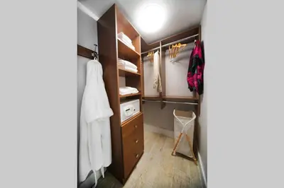 a walk in closet with wooden cabinets and towels at Incredible Ocean Views! Terrace, 1800 sq.ft., Hotel in Miami Beach