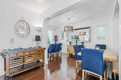 a dining room with a table and chairs and a clock at villa venezia bb in Miami Beach