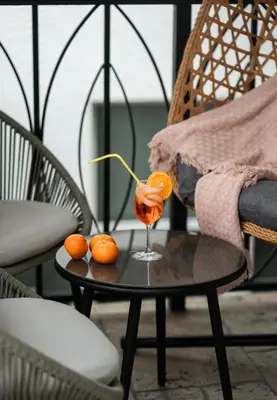 a table with a drink and two oranges on it at Fountain condo 2 story Pool BBQ Balcony in Miami Beach