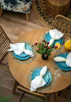 a wooden table with blue plates and napkins on it at Fountain condo 2 story Pool BBQ Balcony in Miami Beach