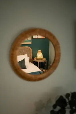 a mirror reflecting a bedroom with a bed and a table at Fountain condo 2 story Pool BBQ Balcony in Miami Beach