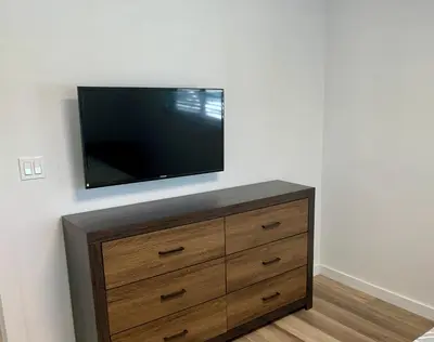 a flat screen tv sitting on top of a dresser at Harbourside Flats in Fort Lauderdale