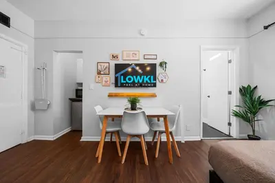 a dining room with a table and two chairs at Nine20 Collins Apartments by Lowkl in Miami Beach