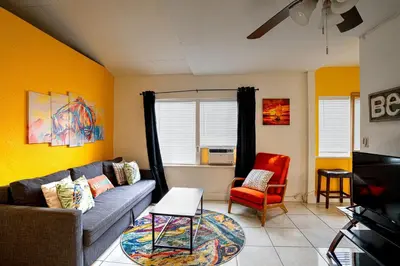 a living room with a couch and a chair at Little Paris by the ocean self check in in Fort Lauderdale