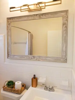 a bathroom with a mirror and a sink at Sophisticated Dania Beach Suites Near the Beach in Dania Beach