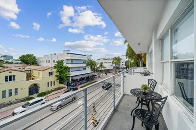 a balcony with a table and chairs and a view of a city at Rock Apartments by Lowkl in Miami Beach