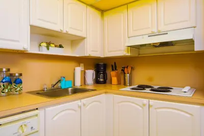 a kitchen with white cabinets and a sink at Sunny Isles Ocean Reserve Condo Apartments - 1BR #812 in Miami Beach