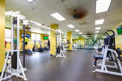 a gym with several tread machines and people in it at Sunny Isles Ocean Reserve Condo Apartments - 1BR #812 in Miami Beach