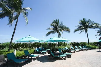 a row of chairs and umbrellas on a beach at Apartamento en la Playa The Tides in Hollywood