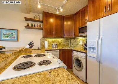 a kitchen with a stove and a white refrigerator at South Maui Condos in Miami Beach