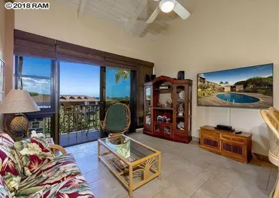 a living room with a couch and a large window at South Maui Condos in Miami Beach
