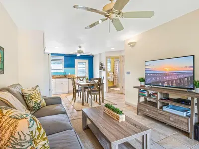 a living room with a couch and a flat screen tv at South Maui Condos in Miami Beach