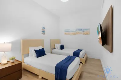 a bedroom with two beds and a television in it at Beachfront Resort - Hot Tub & Pool- Near Beach in Hollywood