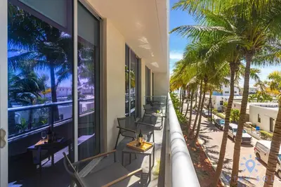 a balcony of a hotel with chairs and palm trees at Beachfront Resort - Hot Tub & Pool- Near Beach in Hollywood