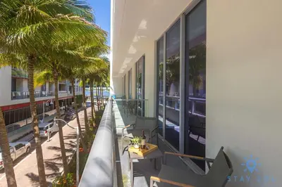 a balcony of a hotel with palm trees and a building at Beachfront Resort - Hot Tub & Pool- Near Beach in Hollywood