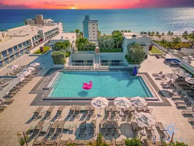 an overhead view of a pool with chairs and umbrellas at Beachfront Resort - Hot Tub & Pool- Near Beach in Hollywood