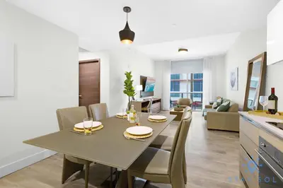 a dining room and living room with a table and chairs at Tropical Oasis - Rooftop Pool- Near Beach - Gym in Hollywood