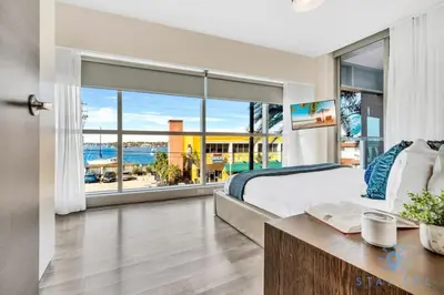 a bedroom with a bed and a view of the ocean at Apartment with Bay View Balcony - Pool - Up To 6 - Gym in Hollywood