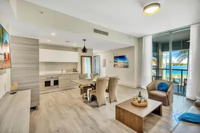 a living room with a kitchen and a dining room at Apartment with Bay View Balcony - Pool - Up To 6 - Gym in Hollywood
