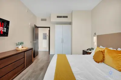 a bedroom with a large bed with yellow pillows at Condo Resort - Best Stay - Balcony - Rooftop pool - Gym in Hollywood