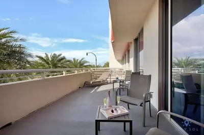 a balcony with a table and chairs on a building at Condo Resort - Best Stay - Balcony - Rooftop pool - Gym in Hollywood