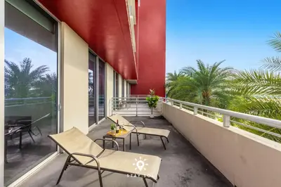 a balcony with chairs and tables on a building at Modern Resort - Terrace - Up To 6 - Near Beach in Hollywood