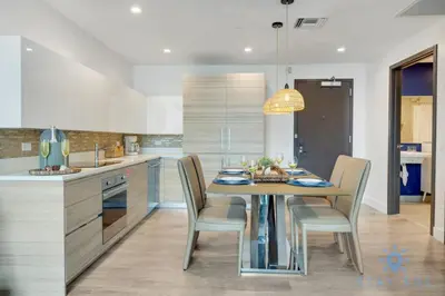 a kitchen with a dining table and chairs in a kitchen at EXCLUSIVE APARTMENT - Rooftop POOL- Beachfront in Hollywood