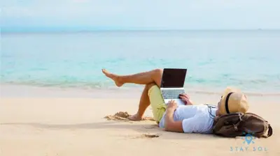 a person laying on the beach with a laptop at Ocean View - Balcony - Hollywood Beach Broad-walk in Hollywood