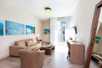 a living room with a couch and a table at NEW!Beachfront Condo Resort- Balcony in Hollywood