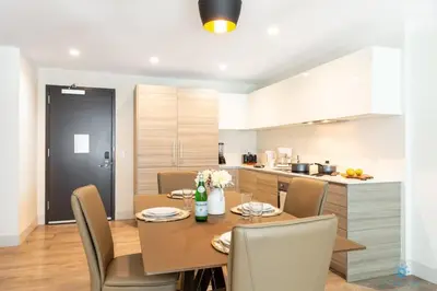 a kitchen and dining room with a table and chairs at NEW!Beachfront Condo Resort- Balcony in Hollywood