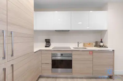 a kitchen with white cabinets and a stove at Bay View - Rooftop Pool - Hollywood Beach Broad -walk in Hollywood