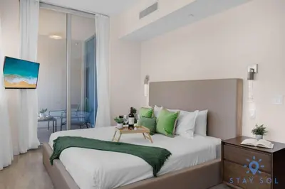 a bedroom with a large bed with green pillows at Bay View - Rooftop Pool - Hollywood Beach Broad -walk in Hollywood