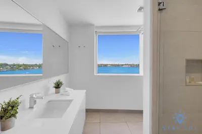 a white bathroom with a sink and a window at Bay View - Rooftop Pool - Hollywood Beach Broad -walk in Hollywood