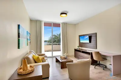 a living room with a couch and a desk at Beachfront Condo-ROOFTO POOL- 2 BEDROOMS 2 BR ! in Hollywood