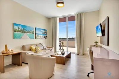 a living room with a couch and a table at Beachfront Condo-ROOFTO POOL- 2 BEDROOMS 2 BR ! in Hollywood