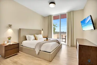 a bedroom with a bed and a large window at Beachfront Condo-ROOFTO POOL- 2 BEDROOMS 2 BR ! in Hollywood
