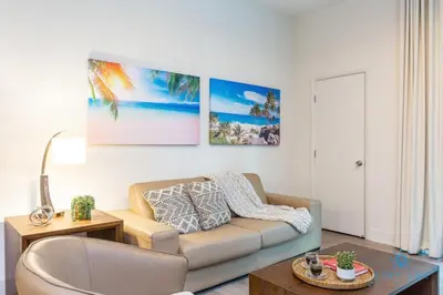 a living room with a couch and a table at NEW LUXURY Beachfront Condo Resort in Hollywood