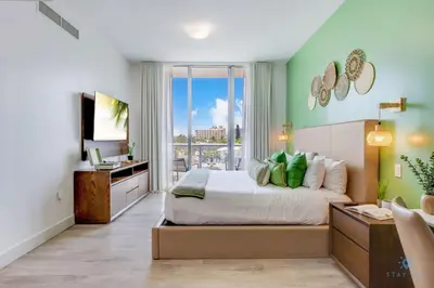 a bedroom with a bed and a large window at Rooftop Pool - Balcony - Hollywood Beach Broad - walk in Hollywood