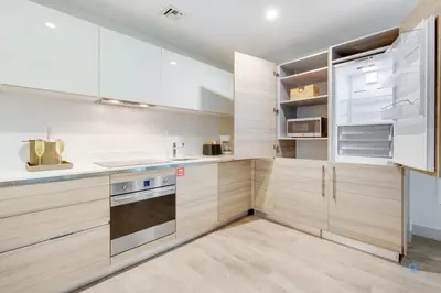 a kitchen with white cabinets and a stove top oven at Rooftop Pool - Balcony - Hollywood Beach Broad - walk in Hollywood