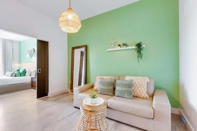 a living room with a couch and a bedroom at Rooftop Pool - Balcony - Hollywood Beach Broad - walk in Hollywood