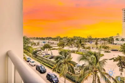 a painting of a view of a parking lot with palm trees at Costa Hollywood - Worth Traveling - Rooftop Pool- Gym in Hollywood