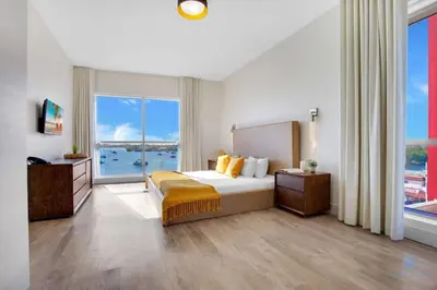 a bedroom with a bed and a large window at Bay View - Balcony - Amazing Pool - Hollywood Beach in Hollywood