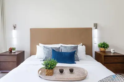 a bedroom with a large white bed with blue pillows at Amazing Pool - Hot Tub - Gym - Hollywood Beach in Hollywood