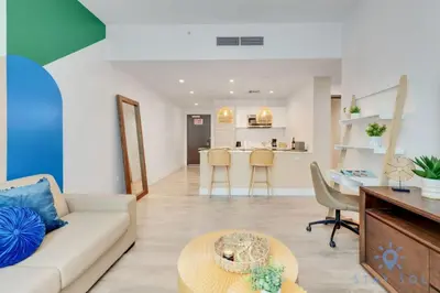 a living room with a couch and a table at Lx Oasis Beachfront-Rt infinity POOL in Hollywood